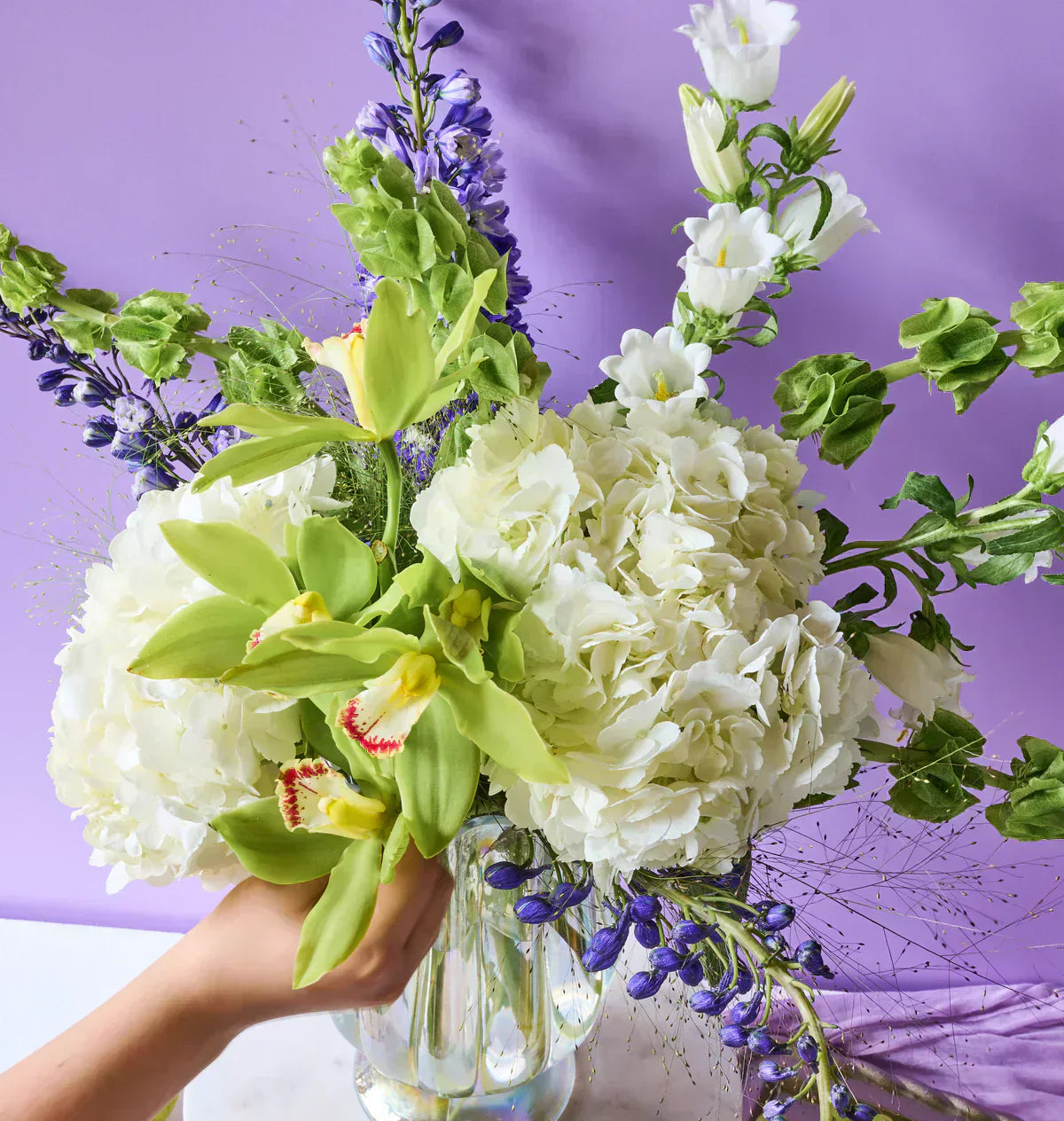Flowers for Dreams Botanica bouquet featuring lush blue hydrangeas and fresh seasonal blooms.