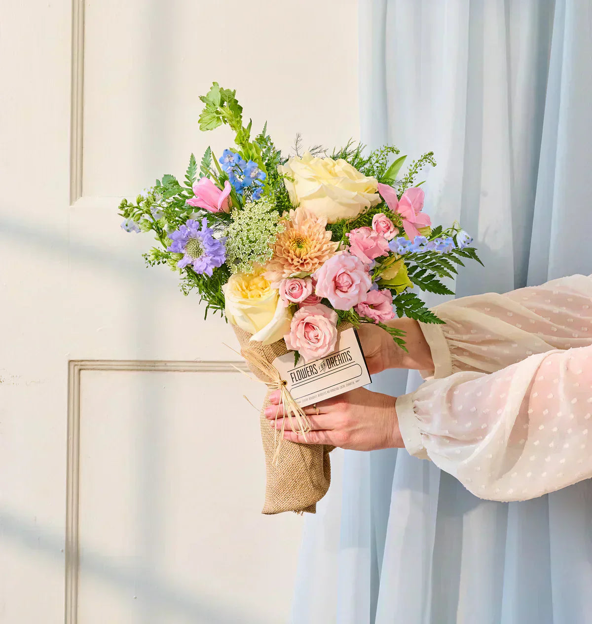 Candlelight garden roses, Queen Anne's lace, and belladonna delphinium in a lavender-toned Mother’s Day bouquet.