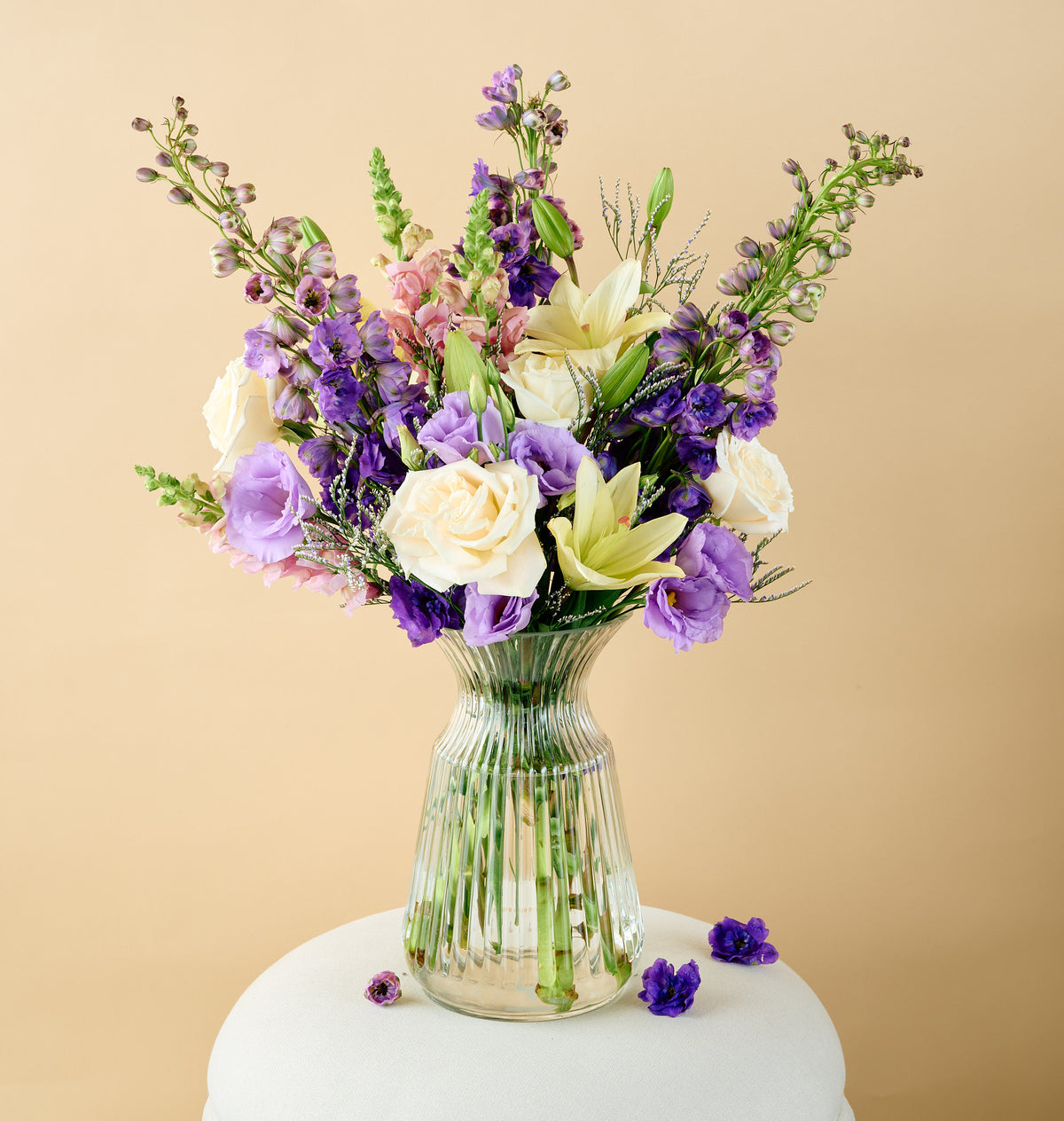 Elegant white lily plant with glossy green leaves in a modern ceramic pot, styled indoors by Flowers for Dreams