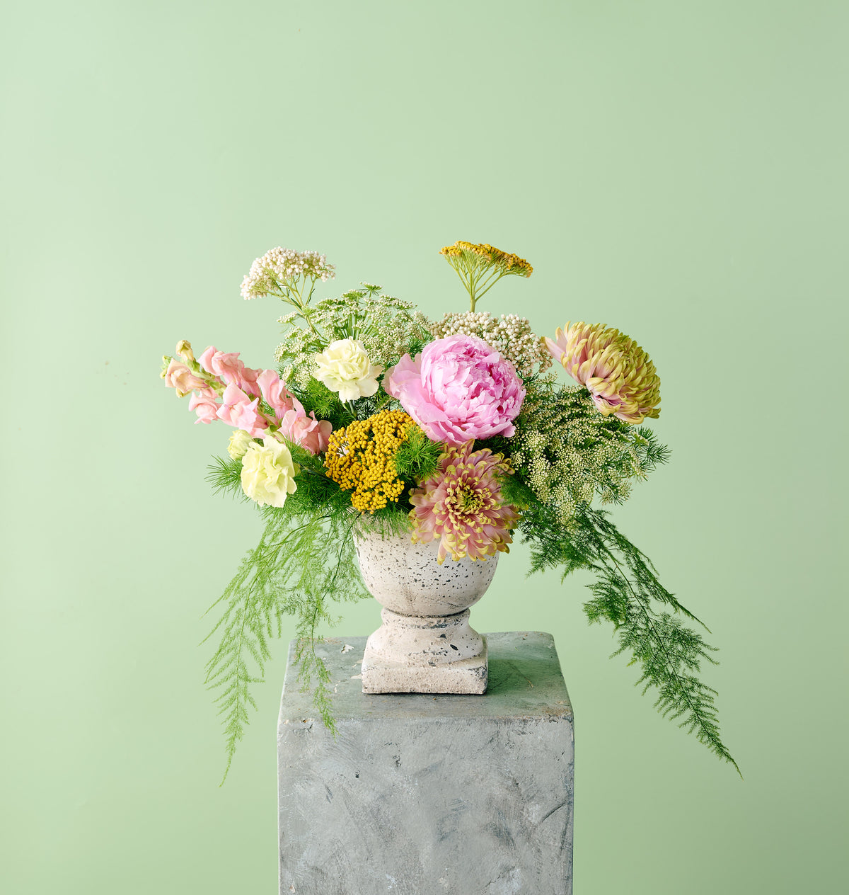 Soft pastel floral arrangement with delicate seasonal blooms in blush, cream, and lavender tones by Flowers for Dreams.